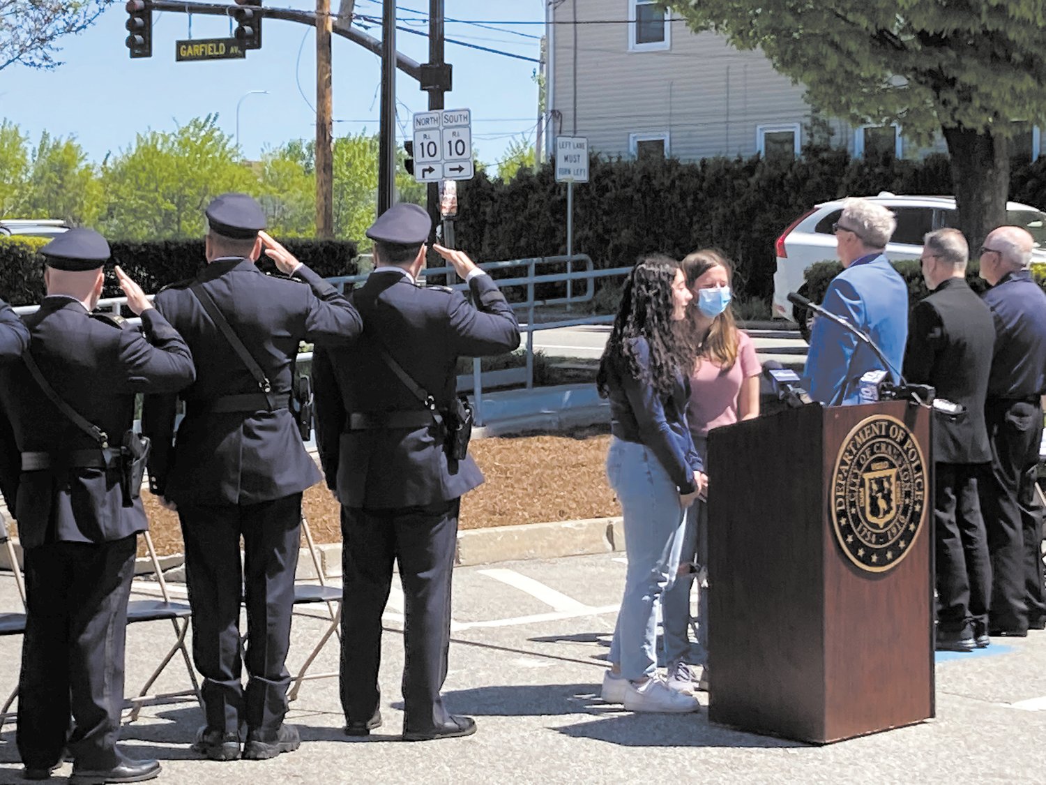 AMERICAN RECOGNITION: Local students, Hailey Bobeck and Marina Mancini, sing the National Anthem at Cranston’s police memorial service on May 18.